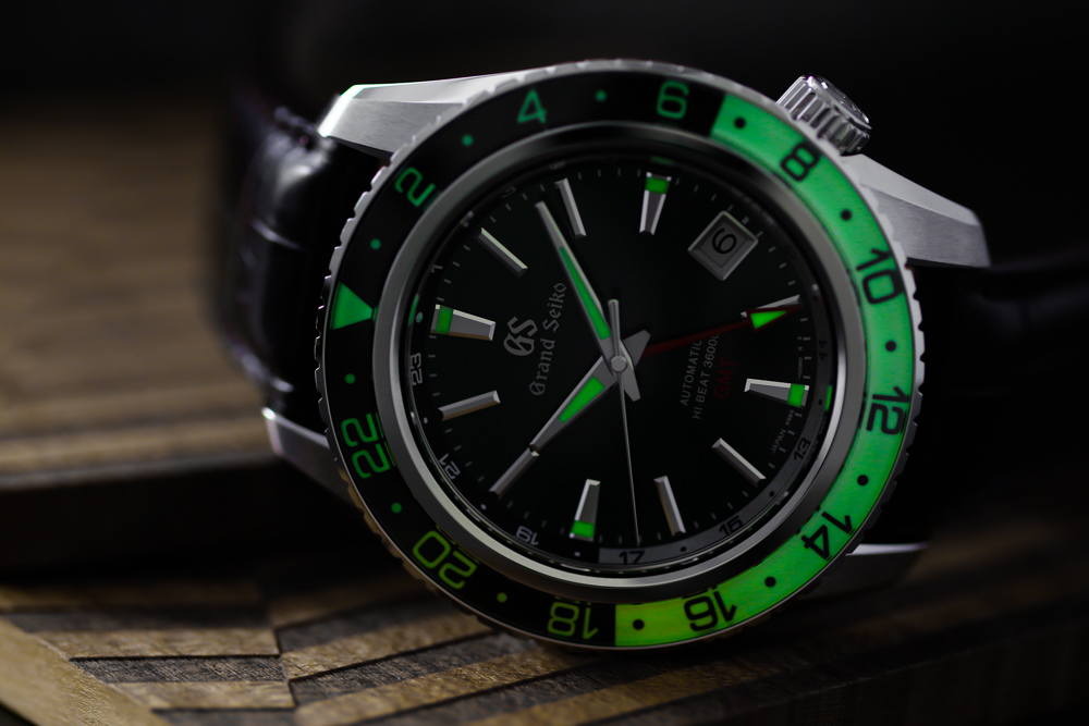 Grand Seiko SBGJ239 Hi-Beat GMT green-dial men's wristwatch glowing in the dark