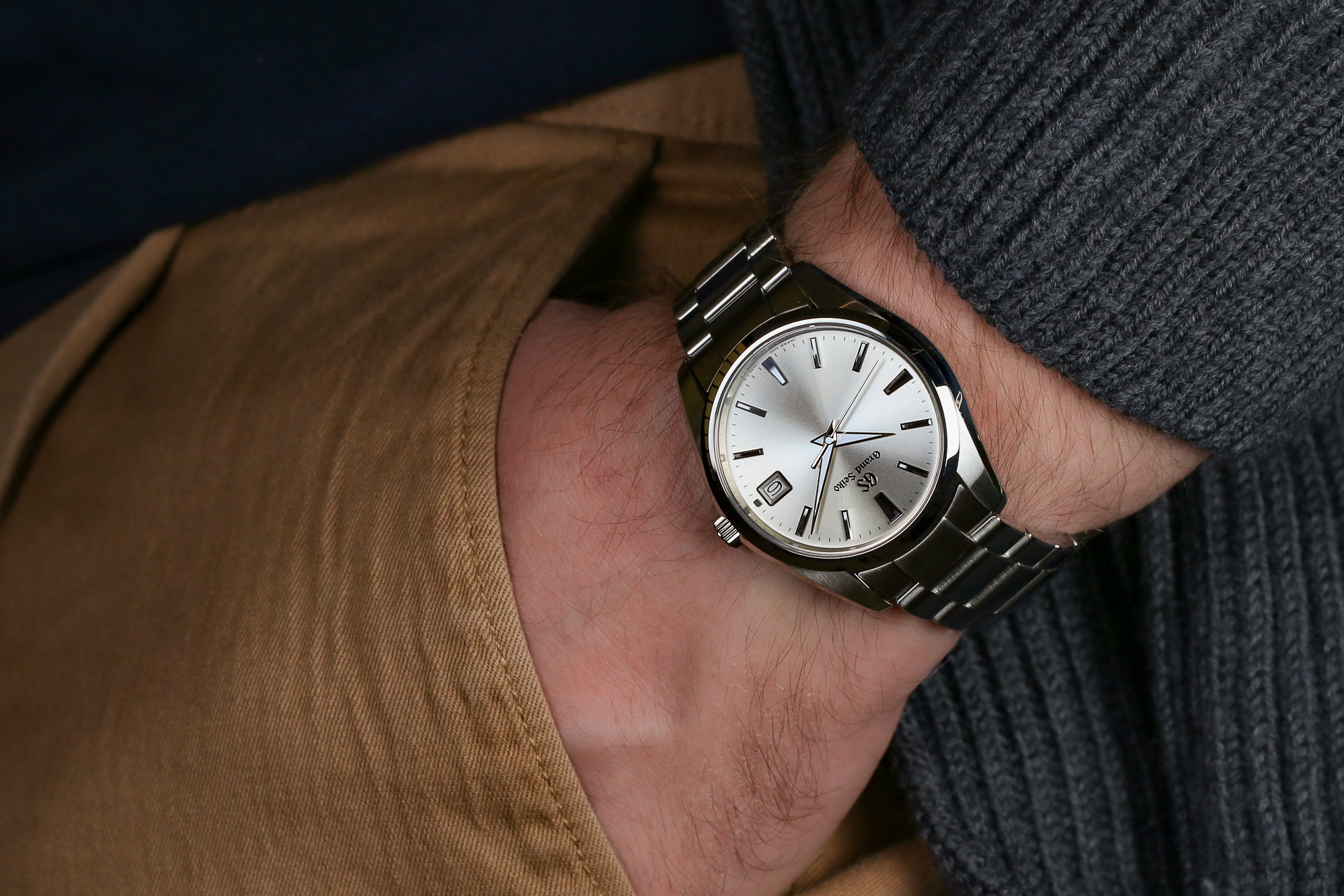 Grand Seiko SBGP009 stainless steel wristwatch worn on the wrist.