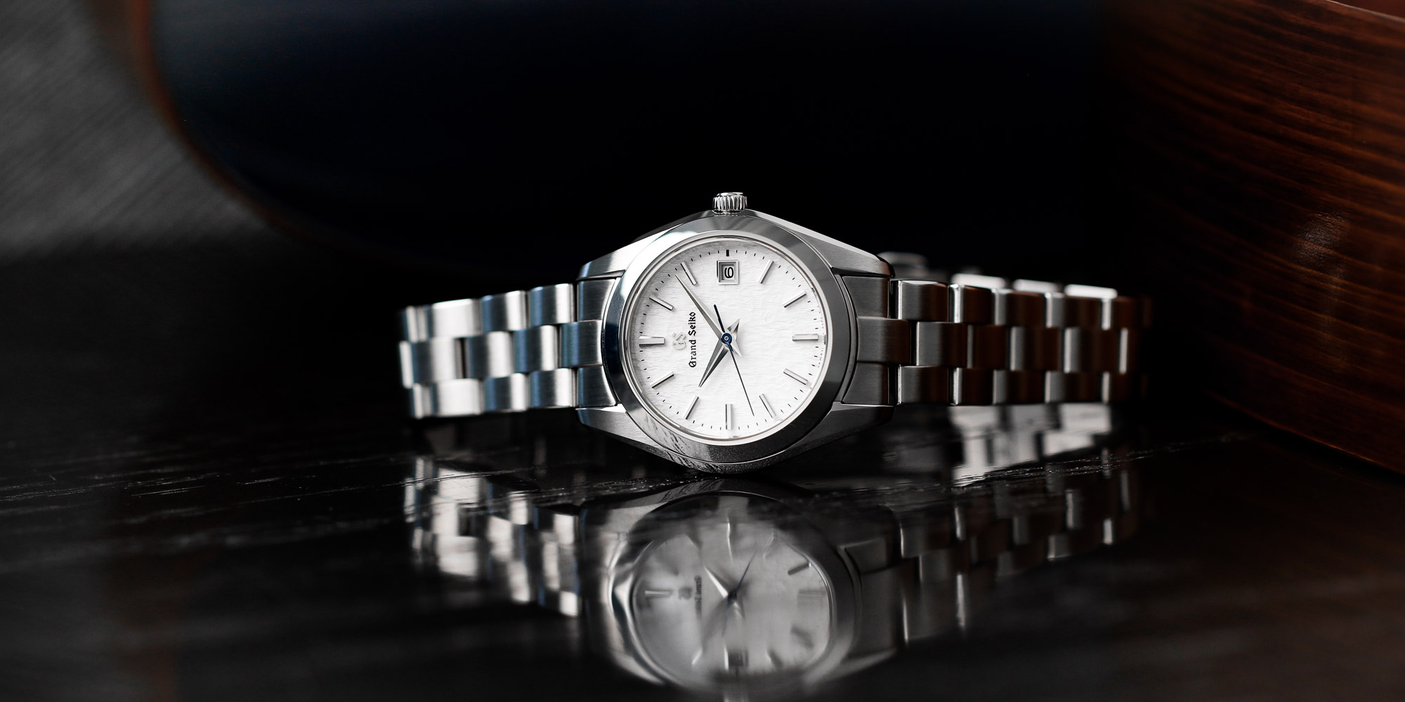 Grand Seiko STGF359 white dial wristwatch on a tabletop