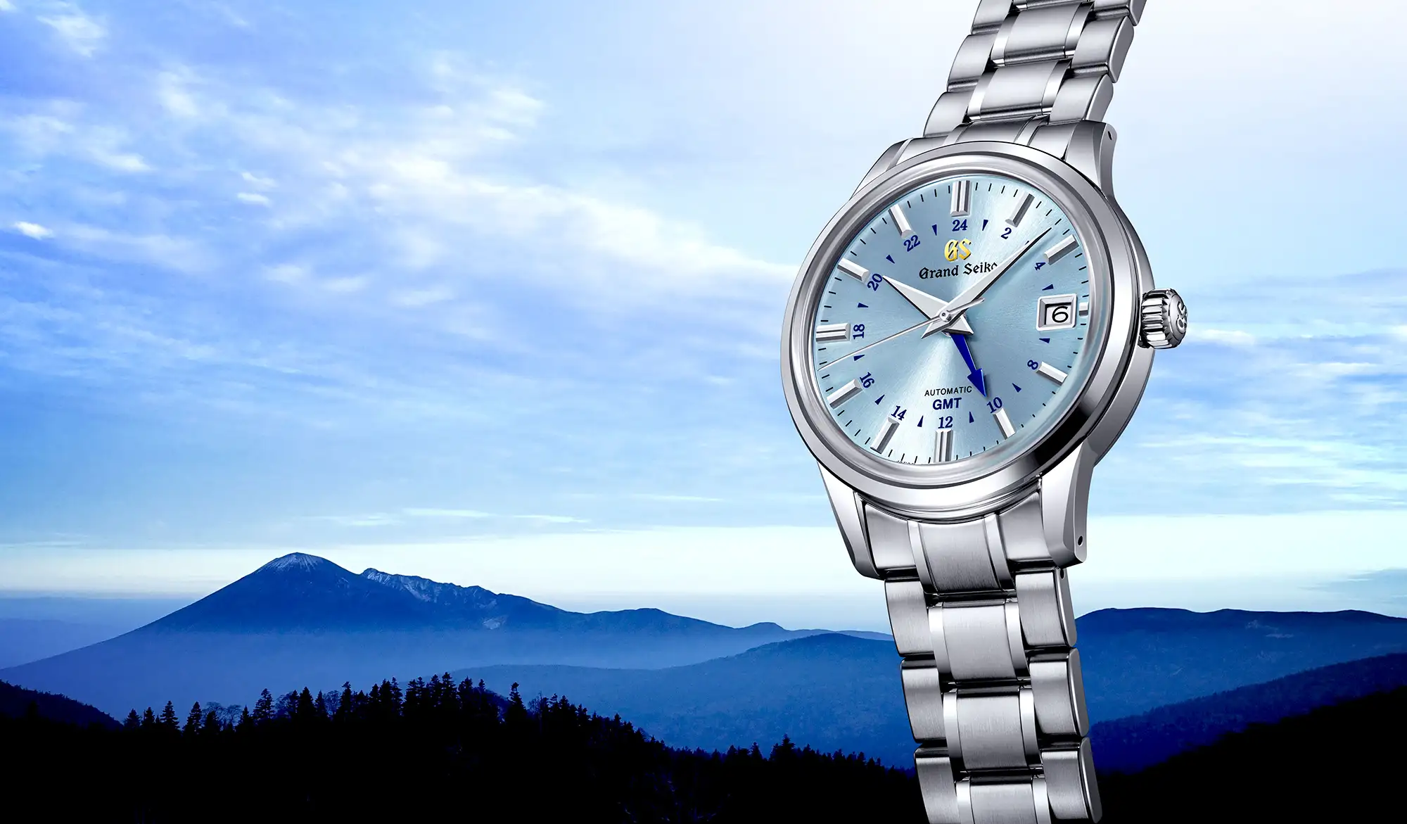 Grand Seiko SBGM253 mechanical watch against mountain-scape.